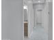 Hallway with gray walls, white trim, and marble floors leading to a bathroom with granite vanity top at 6752 W Citrus Way, Glendale, AZ 85303