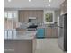 Stylish kitchen featuring stainless appliances, light-colored cabinets, and elegant marble countertops at 6752 W Citrus Way, Glendale, AZ 85303