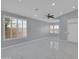 Spacious living room featuring modern tile floors, ceiling fan, neutral walls, and great natural light at 6752 W Citrus Way, Glendale, AZ 85303