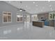 Open-concept living and kitchen area with recessed lighting, ceiling fan, and modern tile floors at 6752 W Citrus Way, Glendale, AZ 85303