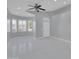 Bright and open living room features multiple windows, neutral colors, ceiling fan, and modern tile floors at 6752 W Citrus Way, Glendale, AZ 85303