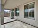 Covered patio area with concrete flooring, windows, and a sliding glass door at 6752 W Citrus Way, Glendale, AZ 85303