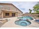 A luxurious backyard featuring a pool, spa, barbecue, and lush landscaping at 6833 W Tether Trl, Peoria, AZ 85383