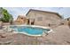 View of a luxurious backyard with a pool, patio, and lush landscaping at 6833 W Tether Trl, Peoria, AZ 85383