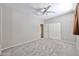 Cozy bedroom with carpet, fan, and closet; creating a tranquil space at 6833 W Tether Trl, Peoria, AZ 85383