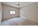 Bedroom with neutral carpet, ceiling fan and blind-covered window at 6833 W Tether Trl, Peoria, AZ 85383