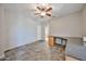 Spacious room with ceiling fan, tile flooring, and custom desk; perfect for an office or study at 6833 W Tether Trl, Peoria, AZ 85383