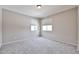 Bright bedroom features neutral walls and carpet, with natural light from the two windows at 6833 W Tether Trl, Peoria, AZ 85383