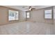 Bedroom featuring tiled floors, a ceiling fan and multiple windows at 6833 W Tether Trl, Peoria, AZ 85383