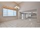 Dining room featuring tiled floors, a chandelier and a view of the living room at 6833 W Tether Trl, Peoria, AZ 85383