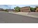 Suburban two-story home featuring a three-car garage and neutral desert landscaping at 6833 W Tether Trl, Peoria, AZ 85383