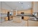 Bright kitchen with stainless appliances, light wood cabinetry, and spacious island; ideal for cooking at 6833 W Tether Trl, Peoria, AZ 85383