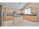 Lovely kitchen with island, light wood cabinets, granite counters, and stainless appliances at 6833 W Tether Trl, Peoria, AZ 85383