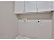 Utility room showing white cabinets and hookups for washer and dryer at 6833 W Tether Trl, Peoria, AZ 85383