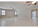 Bright living room featuring tiled floors, a ceiling fan and multiple windows at 6833 W Tether Trl, Peoria, AZ 85383