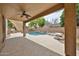 Covered patio view of pool, stone accents, and landscaping at 6833 W Tether Trl, Peoria, AZ 85383