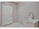 Indoor utility sink near white painted door and gray painted wall at 6833 W Tether Trl, Peoria, AZ 85383