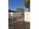 Metal fence and decorative gate providing access to a gravel-covered side yard at 740 N Oracle --, Mesa, AZ 85203