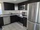 Modern kitchen featuring stainless-steel appliances, dark cabinets, and gray countertops at 740 N Oracle --, Mesa, AZ 85203