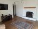 Spacious living room with a fireplace, wooden floors, and a decorative rug, perfect for entertaining at 740 N Oracle --, Mesa, AZ 85203