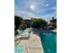 Inviting community pool area featuring lounge chairs and lush landscaping at 7432 E Hum Rd # 203, Carefree, AZ 85377