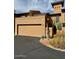 Desert home with a tan stucco exterior, a two car garage and drought-resistant landscaping at 7432 E Hum Rd # 203, Carefree, AZ 85377