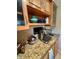 Close-up of kitchen showcasing granite countertops and updated wood cabinets at 7432 E Hum Rd # 203, Carefree, AZ 85377