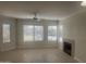 Bright living room with a ceiling fan, fireplace, and plenty of natural light at 7575 E Indian Bend Rd # 1100, Scottsdale, AZ 85250