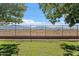 Backyard with green grass, a block wall, and a wrought iron fence with mountain views at 7818 S 74Th Ave, Laveen, AZ 85339