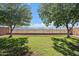 Backyard with green grass, a block wall, and a wrought iron fence with mountain views at 7818 S 74Th Ave, Laveen, AZ 85339