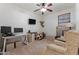 Functional bedroom with workspace, mini fridge, ceiling fan and carpeted floor at 7818 S 74Th Ave, Laveen, AZ 85339