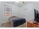 Bright bedroom with a window, closet with sliding doors, and modern ceiling fan at 7818 S 74Th Ave, Laveen, AZ 85339