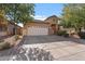 Inviting single-story home with a well-kept front yard, a spacious driveway, and an attached two-car garage at 7818 S 74Th Ave, Laveen, AZ 85339