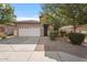 Charming single-story home with a well-manicured front yard and a two-car garage at 7818 S 74Th Ave, Laveen, AZ 85339