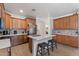 Modern kitchen featuring white quartz counters, stainless appliances, and a breakfast bar at 7818 S 74Th Ave, Laveen, AZ 85339