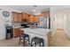Updated kitchen with stainless steel appliances, light countertops, and breakfast bar seating at 7818 S 74Th Ave, Laveen, AZ 85339