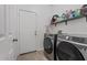 Well-equipped laundry room with modern Samsung washer and dryer, storage shelves, and access door at 7818 S 74Th Ave, Laveen, AZ 85339