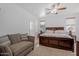 Serene main bedroom with a cozy seating area, ceiling fan, and large windows for ample natural light at 7818 S 74Th Ave, Laveen, AZ 85339