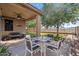 Covered patio featuring neutral decor, a ceiling fan, and an outdoor dining area with mountain views at 7818 S 74Th Ave, Laveen, AZ 85339