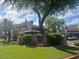 Charming condo complex with lush landscaping and mature shade trees on a partly cloudy day at 9450 E Becker Ln # 2051, Scottsdale, AZ 85260