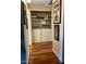Convenient laundry area with washer, dryer, shelves, and wood floor at 9450 E Becker Ln # 2051, Scottsdale, AZ 85260
