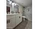 Bathroom with double sinks, white cabinets and marble shower at 954 E Henry St, Tempe, AZ 85288
