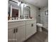 Bathroom with double sinks, white cabinets and marble shower at 954 E Henry St, Tempe, AZ 85288