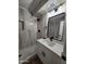 Modern bathroom featuring marble tile walls, stylish vanity, and frameless glass shower at 954 E Henry St, Tempe, AZ 85288