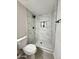 Modern bathroom featuring a tiled walk-in shower with black fixtures and a built-in niche at 954 E Henry St, Tempe, AZ 85288