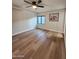 This bedroom features wood floors, a ceiling fan, and a window at 954 E Henry St, Tempe, AZ 85288