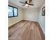 This bedroom features wood floors, a ceiling fan, and a window at 954 E Henry St, Tempe, AZ 85288