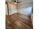 This bedroom features wood floors, a ceiling fan, a closet, and a window at 954 E Henry St, Tempe, AZ 85288
