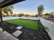 Landscaped front yard features an easy-care artificial turf lawn, decorative rock, and a privacy wall at 954 E Henry St, Tempe, AZ 85288