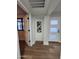 Bright hallway features wood flooring, modern white doors, and eye-catching metal flower wall art at 954 E Henry St, Tempe, AZ 85288